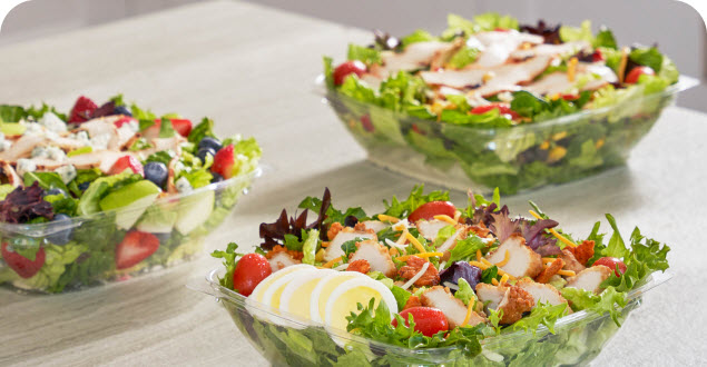 Three salads in plastic bowls, featuring various protein including nuggets, filet and grilled filet