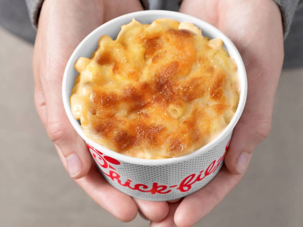 Pair of hands holding Mac & Cheese in a Chick-fil-A bowl