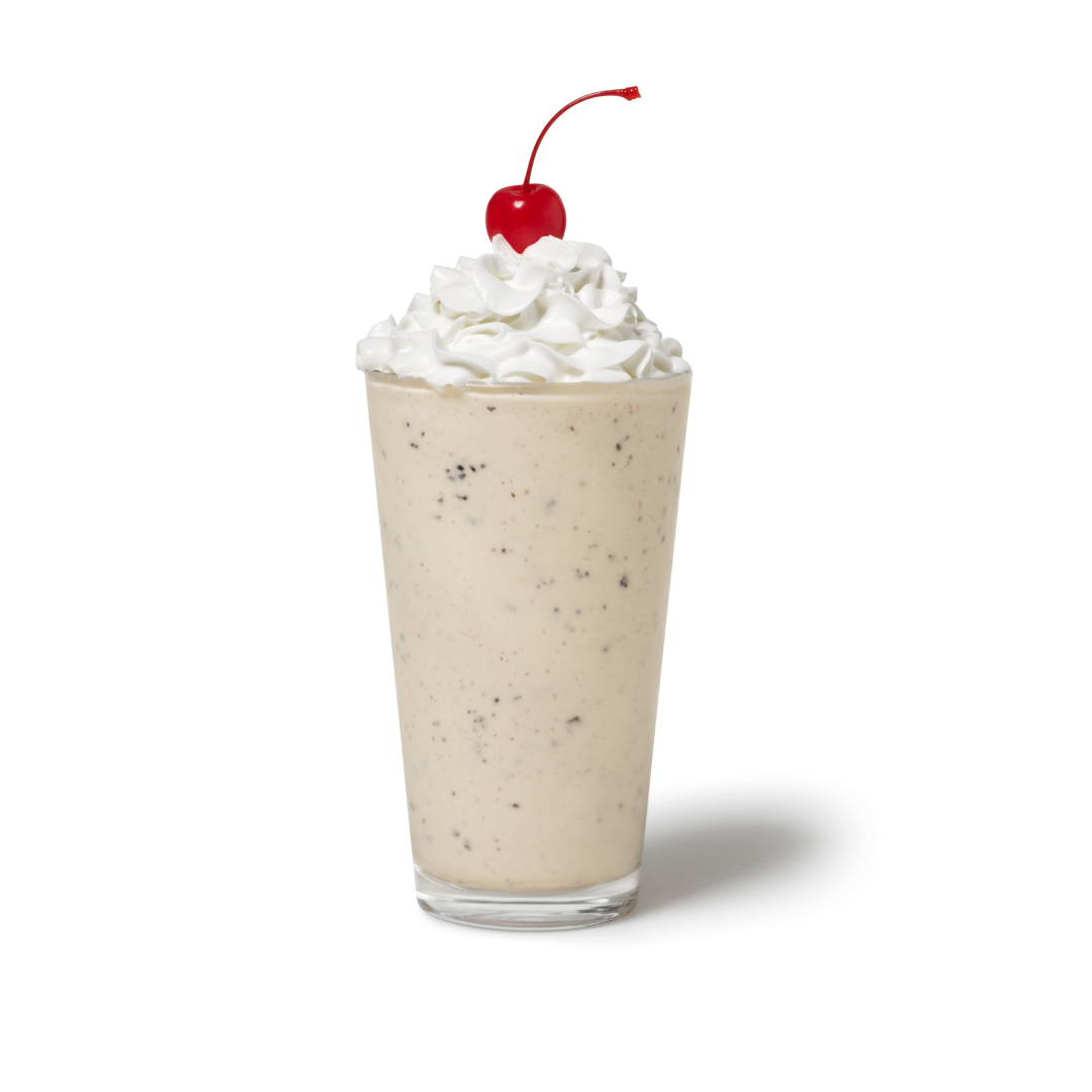 Cookies & Cream Milkshake with whipped cream and a cherry on top in a cup, with NUTRIGRADE 'D' at 20% sugar