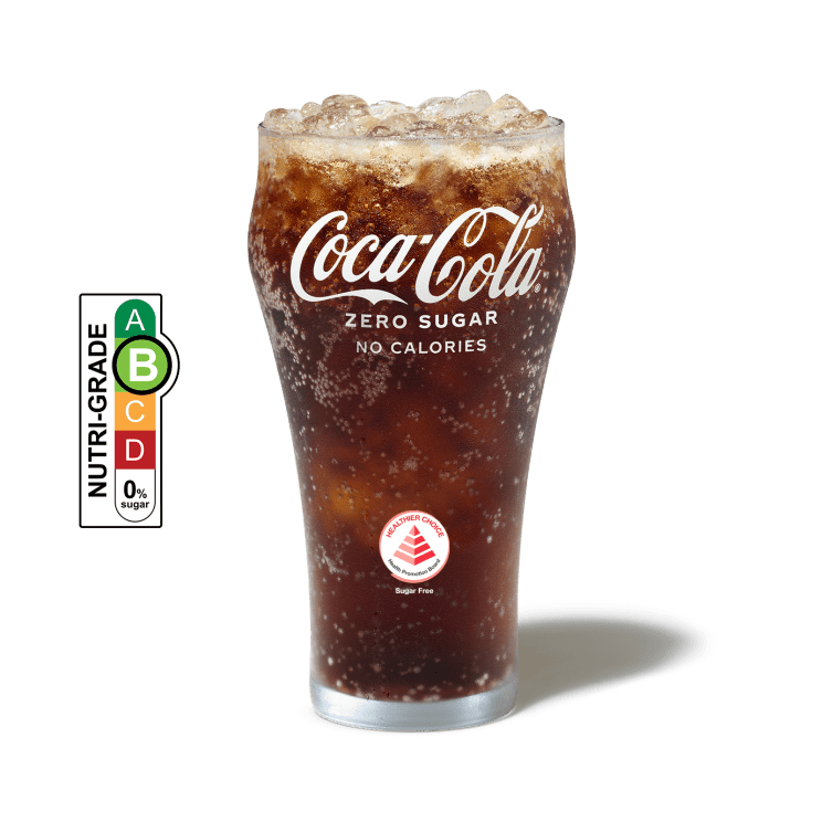 Coca-Cola Zero Sugar with ice in a cup and NUTRIGRADE label with a gradient rating scale that has four sections labeled A, B, C, and D, progressing from green to red; Rating is light green “B” with 0% sugar.