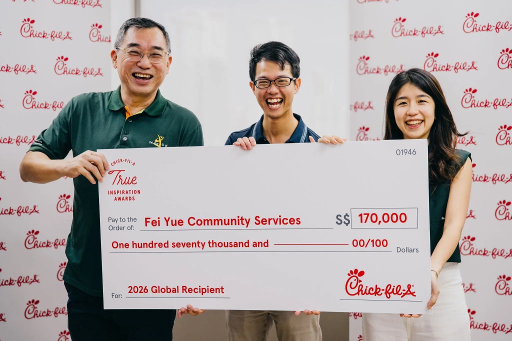 Fei Yue Community Services holding their grant cheque.